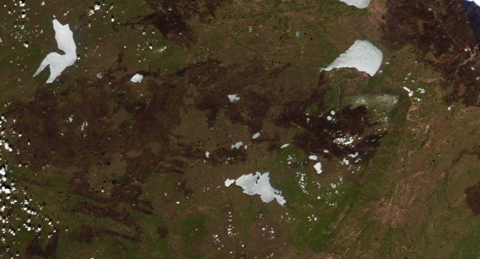 A Zoom Earth image from May 4, 2024 shows the vast 2023 and 2024 burn areas of fires stretching from Sambaa K'e, top left, to the NWT-Alberta border in the bottom right.